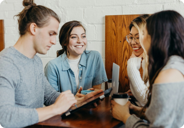 4 people having a conversation round a table