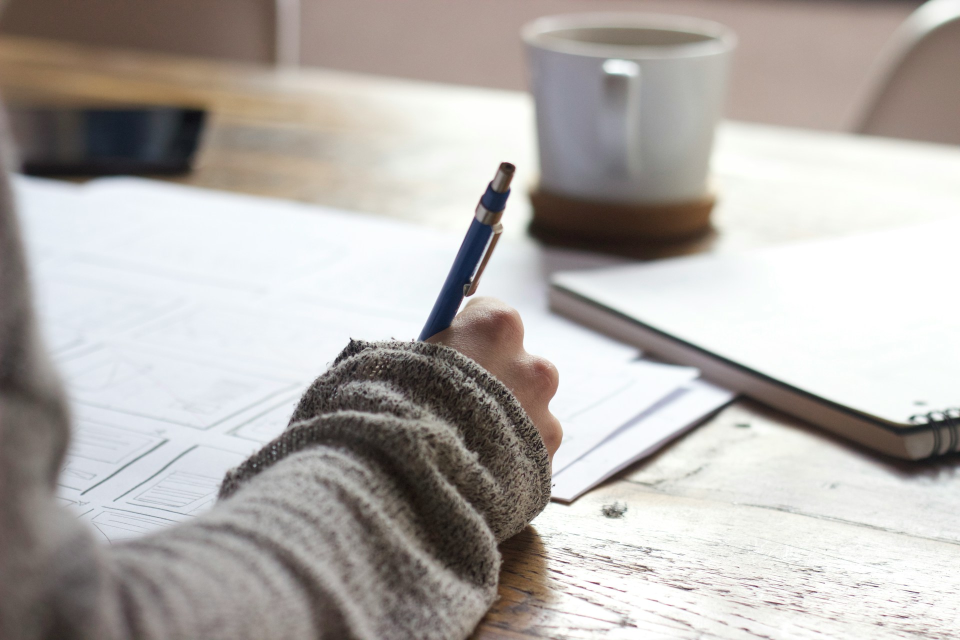 Person writing a story at a desk